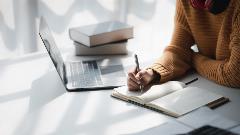 Woman with laptop open studying