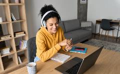 Woman smiling and working on laptop